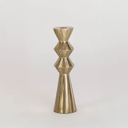 Modern metal candle holder in gold finish with geometric shape for table decor or dining styling contemporary home placement white background.