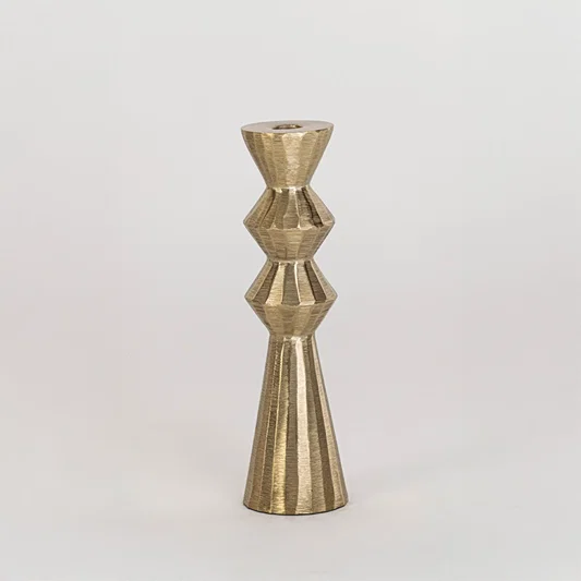 Modern metal candle holder in gold finish with geometric shape for table decor or dining styling contemporary home placement white background.