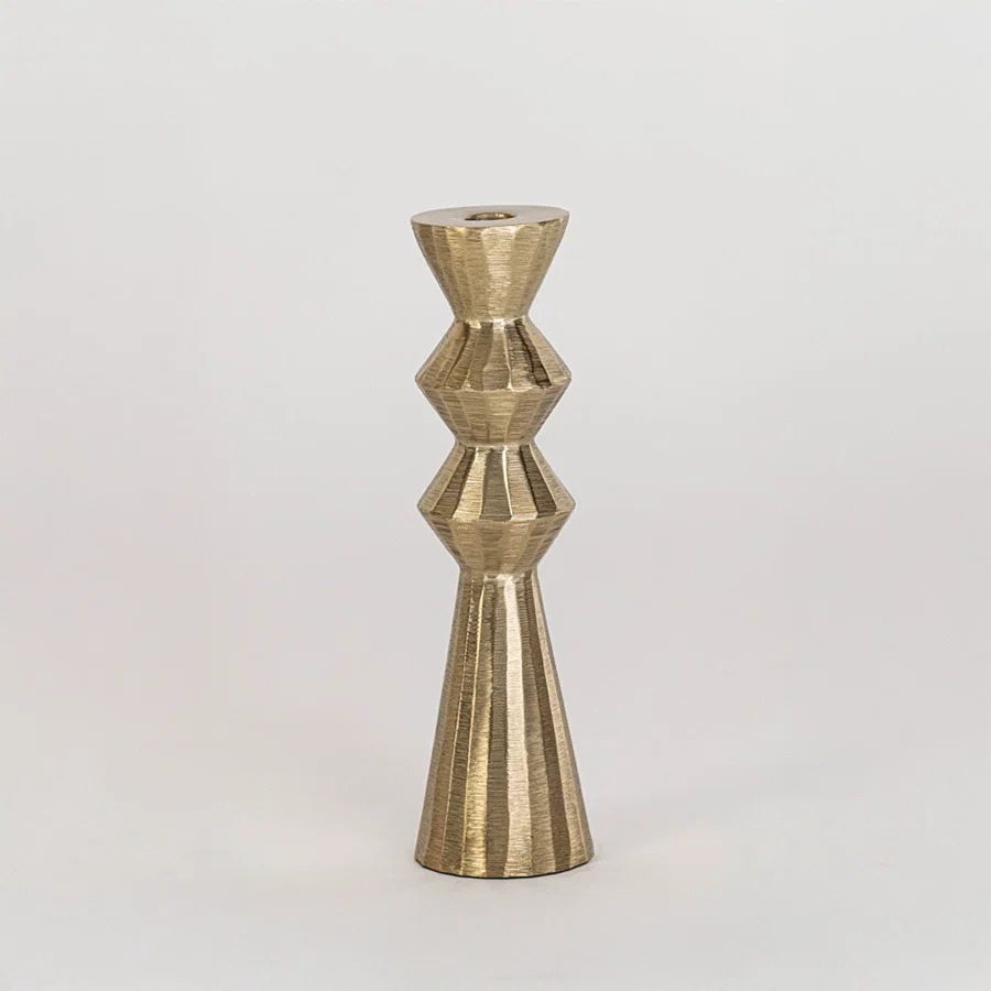 Modern metal candle holder in gold finish with geometric shape for table decor or dining styling contemporary home placement white background.