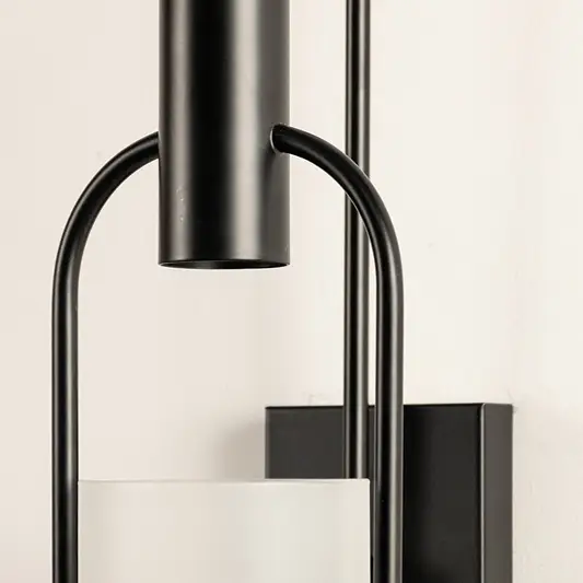Closeup of black metal and clear glass wall light for modern hallway and luxury decor styling spaces.