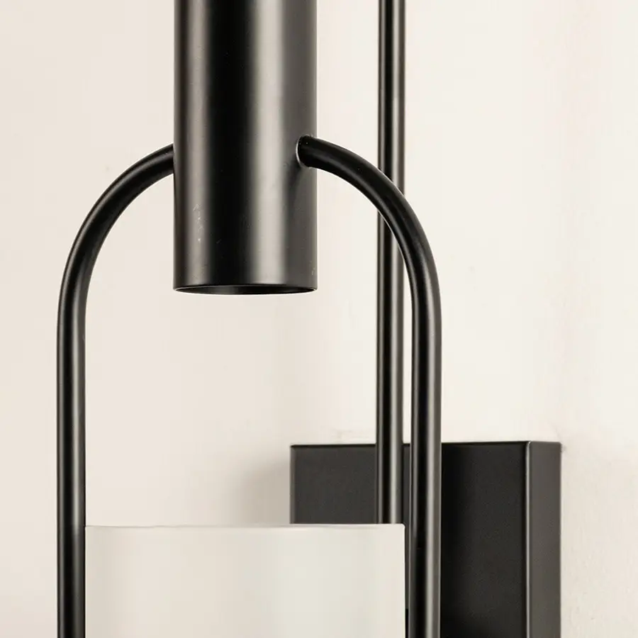 Closeup of black metal and clear glass wall light for modern hallway and luxury decor styling spaces.