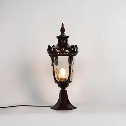 Brown pillar lamp glowing with warm bulb and glass panels shown on white background for stylish outdoor garden lighting.
