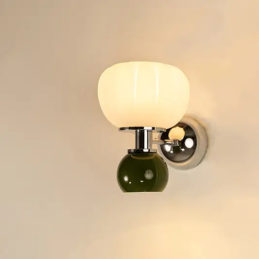Modern white and green glass wall light with warm glow for elegant bedroom and luxury decor spaces.

