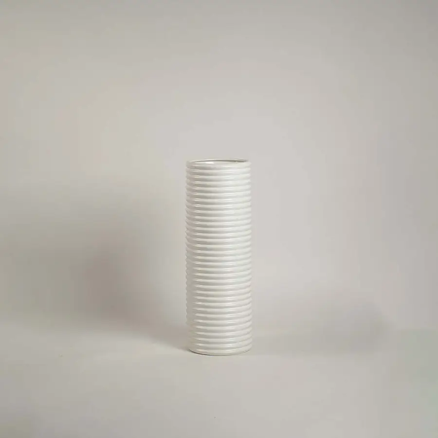 Matte white ceramic cylinder vase featuring a dense horizontal ribbed stacked texture on a clean white background.