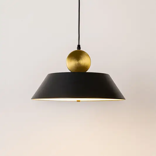 Modern pendant light in black and gold metal finish with dome shade for kitchen or dining decor lighting white background.