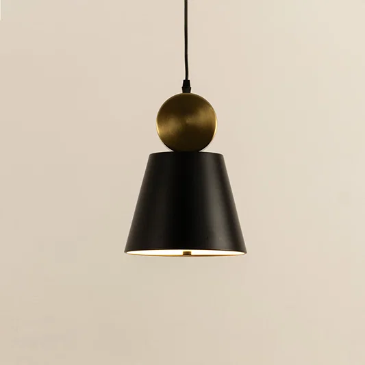 Closeup of black metal pendant light with gold top accent showing minimal cone design and smooth finish for modern interior decor.