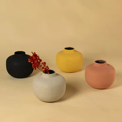 Yellow metal textured vases arranged together creating a vibrant modern decor look ideal for centre tables shelves and consoles.