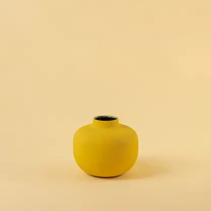 Yellow metal textured vase decor on a clean white background highlighting its bold matte finish for versatile home styling.