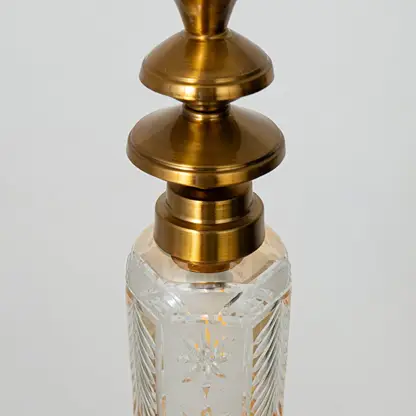 Closeup of patterned glass and gold metal pendant light highlighting intricate texture and premium finish.