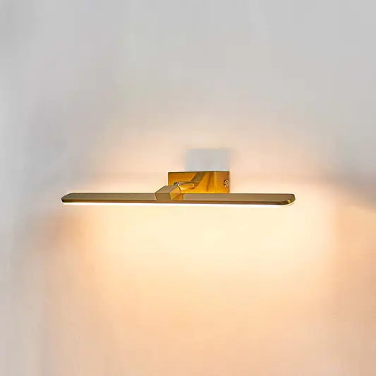 Sleek gold metal LED picture light wall fixture on white background for highlighting artwork and wall mirrors.