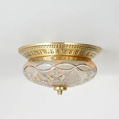 Vintage brass and glass flush ceiling light installed on white ceiling adding classic charm to home interior setting.