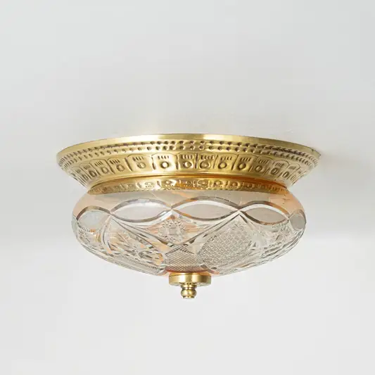Vintage brass and glass flush ceiling light installed on white ceiling adding classic charm to home interior setting.