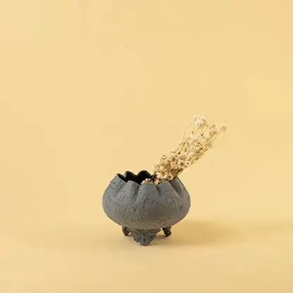 Grey metal scalloped bowl planter decor styled in a warm modern space adding a subtle elegant accent to living room tables.