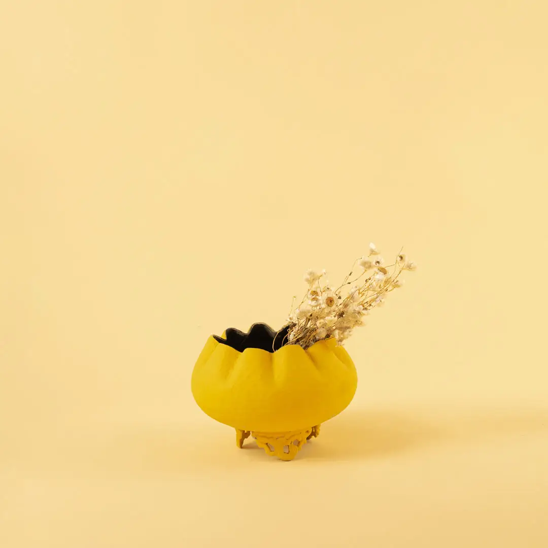 Small yellow textured bowl planter with dried buds for bright modern home decor and stylish tabletop accents.