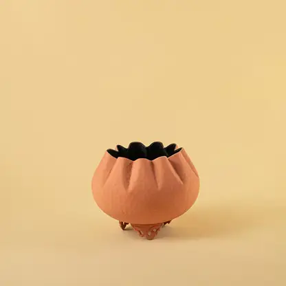 Terracotta metal scalloped bowl planter decor on a clean white background highlighting its textured warm finish for home styling.