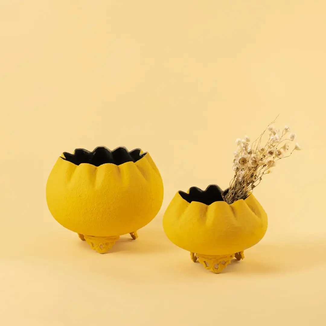Yellow metal scalloped bowl planters displayed together creating a vibrant modern decor look ideal for centre tables and shelves.