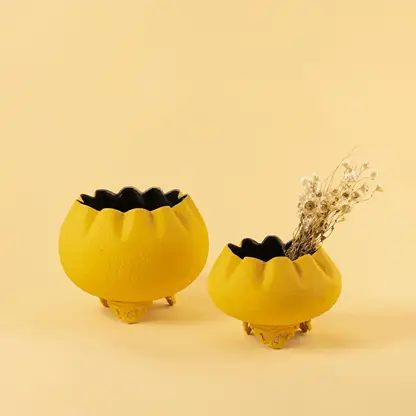 Yellow metal scalloped bowl planters displayed together creating a vibrant modern decor look ideal for centre tables and shelves.