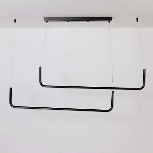 Black hanging light displayed on a white background with lights off showing its minimal modern dual bar structure clearly.
