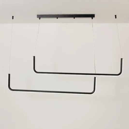Modern black hanging light glowing softly on a bright white background showing a sleek dual bar design for stylish interiors.