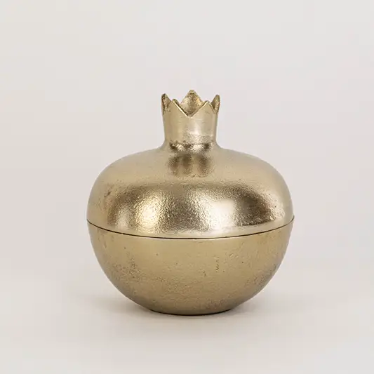 Modern metal decor bowl in gold finish with crown top lid for table decor or shelf styling contemporary home placement white background.