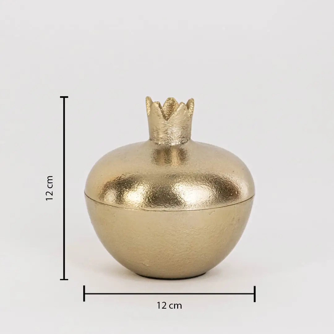 Gold metal pomegranate jar measuring 12 cm tall and 12 cm wide with crown lid and glossy finish shown on white wall