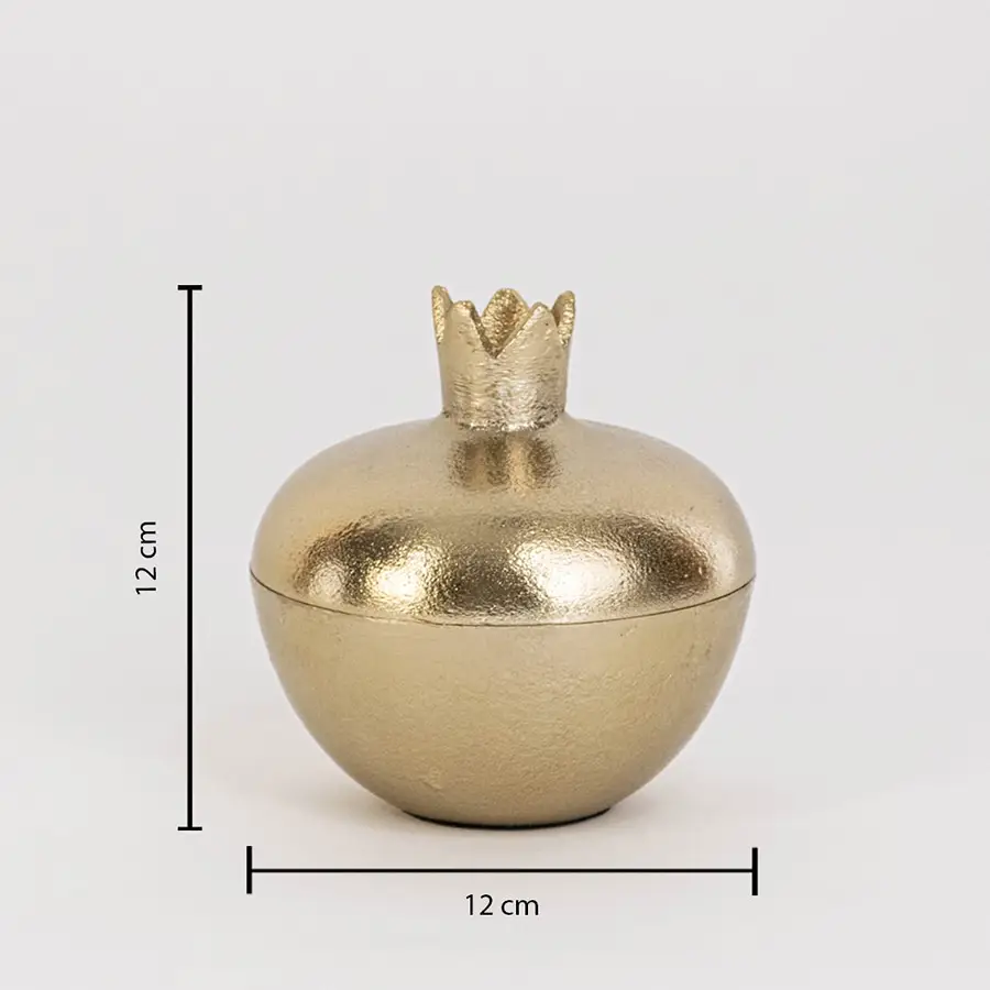 Gold metal pomegranate jar measuring 12 cm tall and 12 cm wide with crown lid and glossy finish shown on white wall