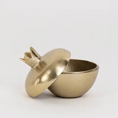 Elegant metal storage bowl in gold finish with crown lid open view for table decor or storage styling modern home placement white background.