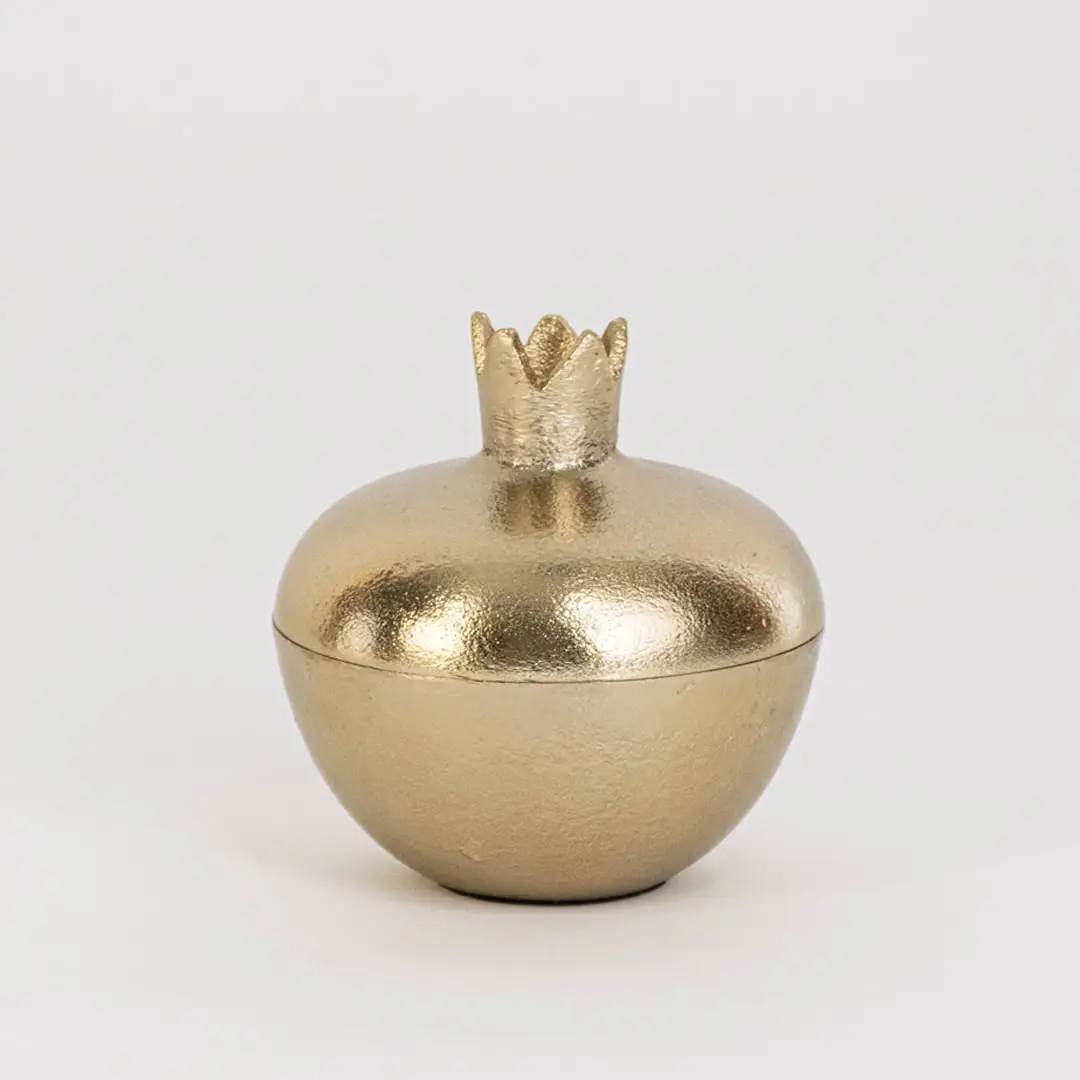 Smooth gold pomegranate-shaped jar with crown top shown on clean white background for clear product presentation