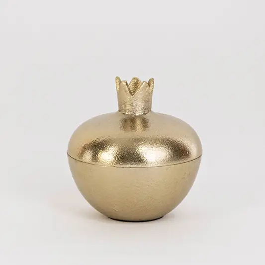 Smooth gold pomegranate-shaped jar with crown top shown on clean white background for clear product presentation