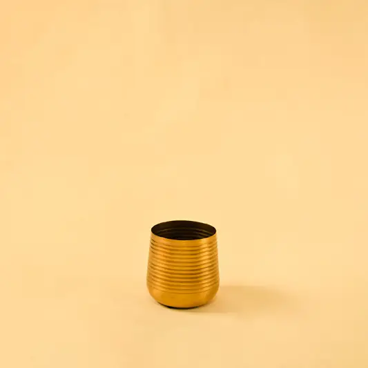 Small metallic gold ridged bud vase for elegant modern home decor and stylish minimalist tabletop accents.
