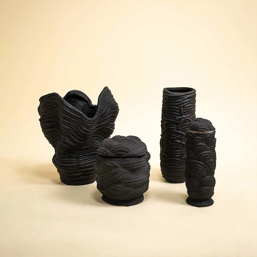 Set of black ceramic decorative sculptures with textured organic forms for contemporary shelf styling and home decor.