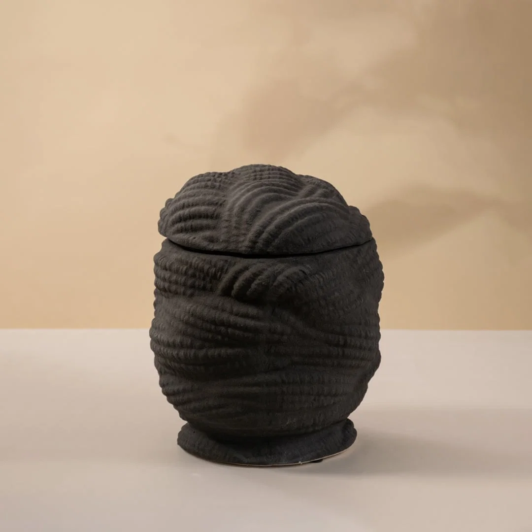 Black ceramic decorative sculpture with layered textured silhouette for elegant tabletop styling and modern home decor.
