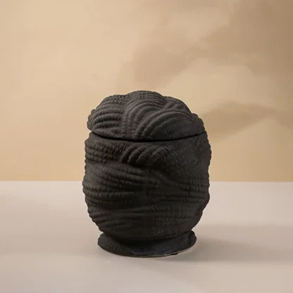 Black ceramic decorative sculpture with layered textured silhouette for elegant tabletop styling and modern home decor.