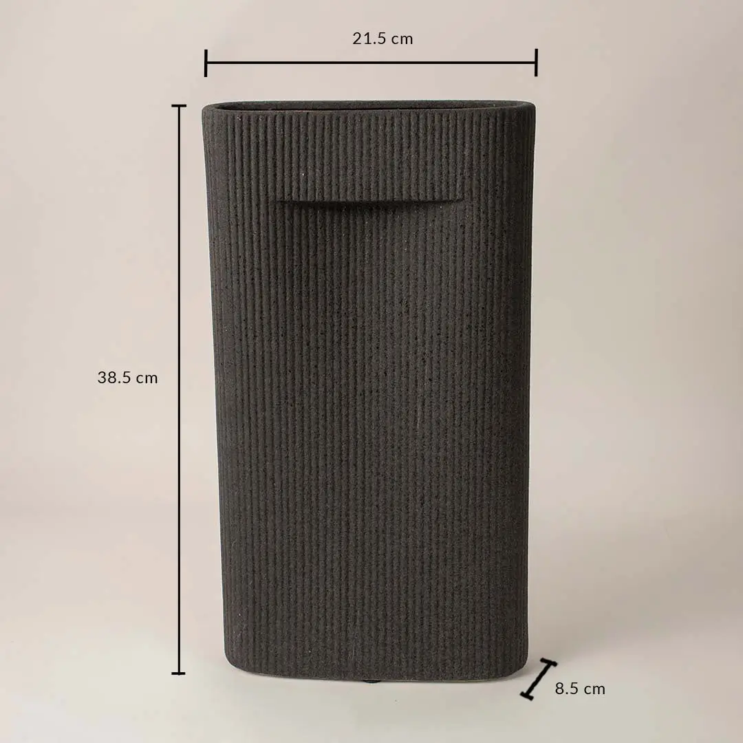 Black cylindrical textured ceramic vase with dimension display placed on white surface against neutral background highlighting size and contemporary decor design.