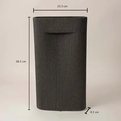 Black cylindrical textured ceramic vase with dimension display placed on white surface against neutral background highlighting size and contemporary decor design.
