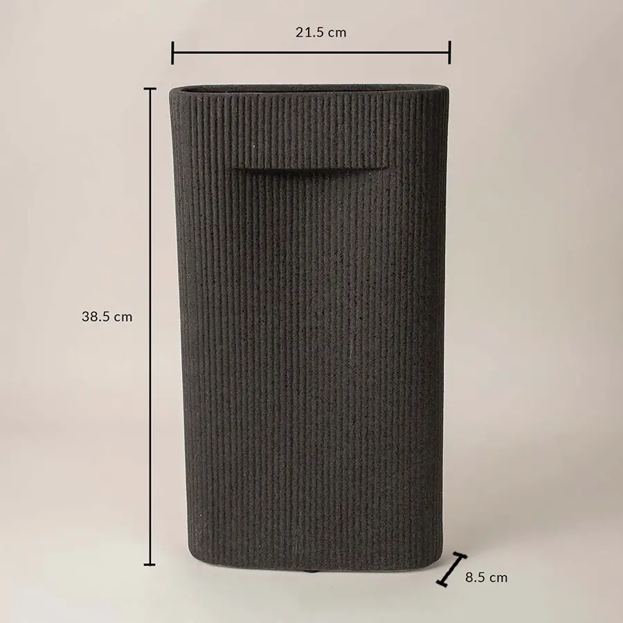 Black cylindrical textured ceramic vase with dimension display placed on white surface against neutral background highlighting size and contemporary decor design.