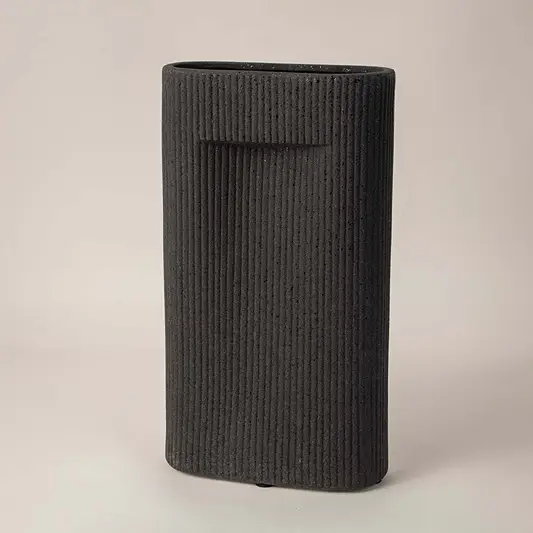 Side angle view of black rectangular ceramic vase with grooved texture perfect for living room or office interior styling.