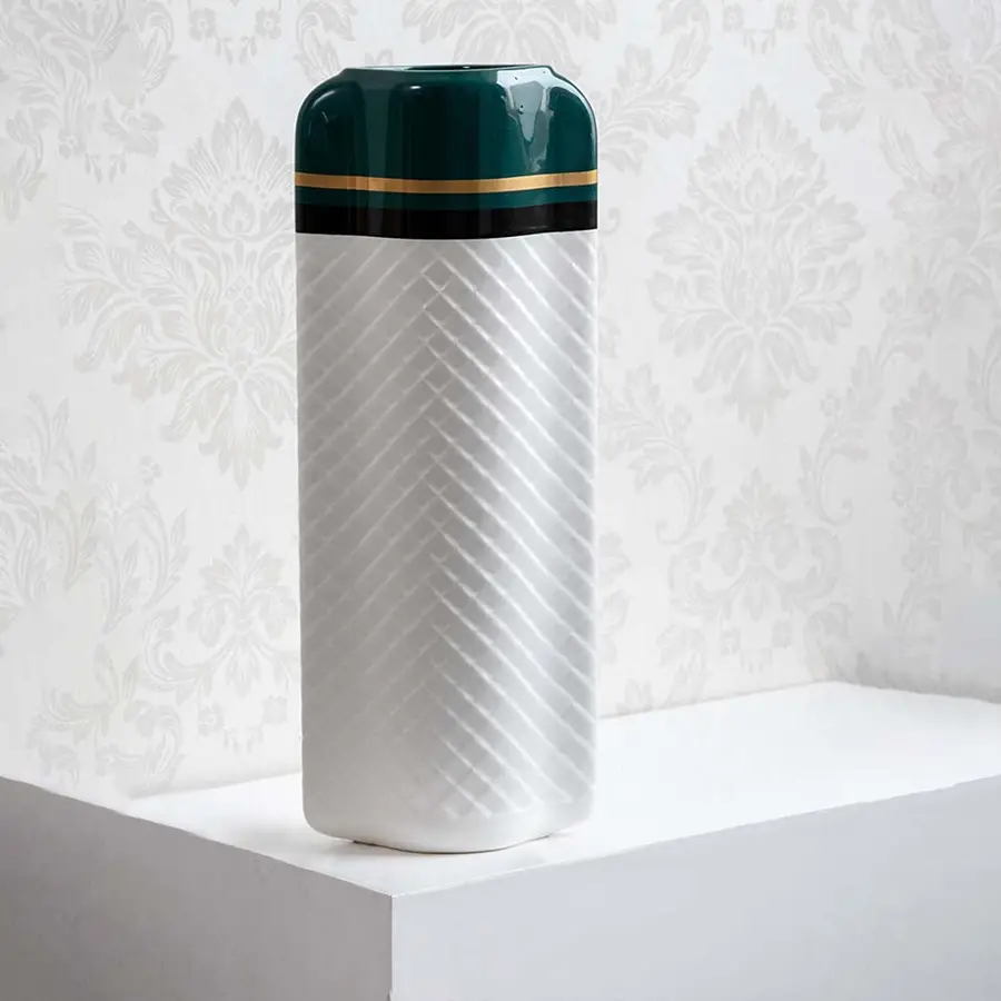 Textured white and green geometric vase for elegant modern home decor and sophisticated shelf accent style.