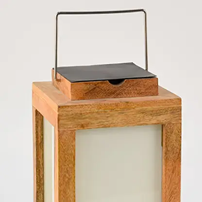 Closeup view of wooden solar lantern showing smooth natural wood texture frosted glass and detailed metal solar top finish.