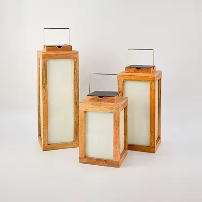 Set of multiple wooden solar lanterns in different sizes arranged together for outdoor ambiance and decorative garden lighting.