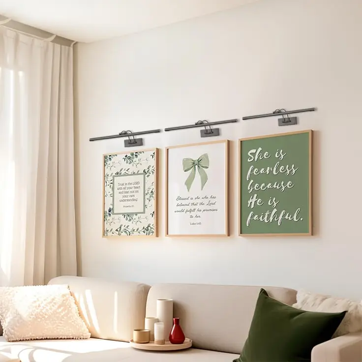 Grouped lifestyle view of modern metal picture lights enhancing wall art and home decor styling.