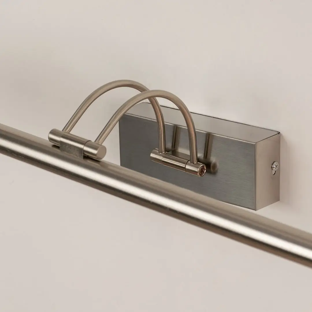 Closeup view of modern metal picture light with slim adjustable bar for focused wall illumination.