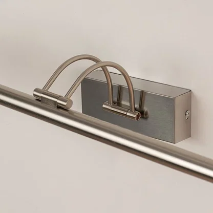 Closeup view of modern metal picture light with slim adjustable bar for focused wall illumination.