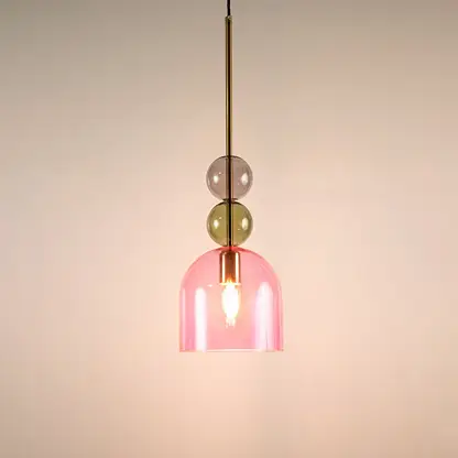 Green and pink glass pendant light illuminated to showcase modern decorative ceiling lighting with elegant appeal.
