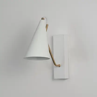 White wall light with conical shade and gold arm shown off on white background for modern bedroom and living room decor.