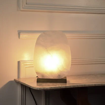 Marble effect globe table lamp with glowing stone shade creating soft ambient lighting for luxury interior decor.