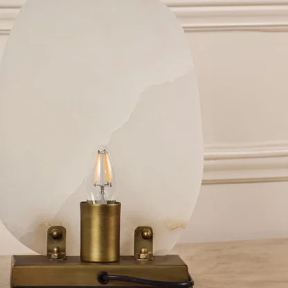 Closeup of marble table lamp showing natural veining and brass base craftsmanship reflecting premium quality and elegant design.
