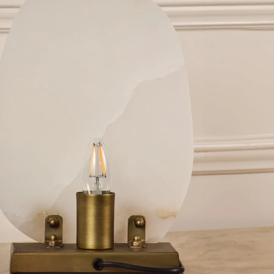 Closeup of marble table lamp showing natural veining and brass base craftsmanship reflecting premium quality and elegant design.