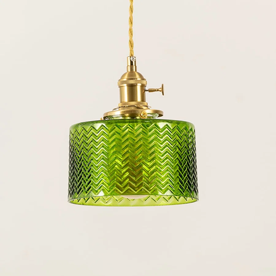 Closeup of green textured glass and brass metal pendant light showcasing premium craftsmanship.