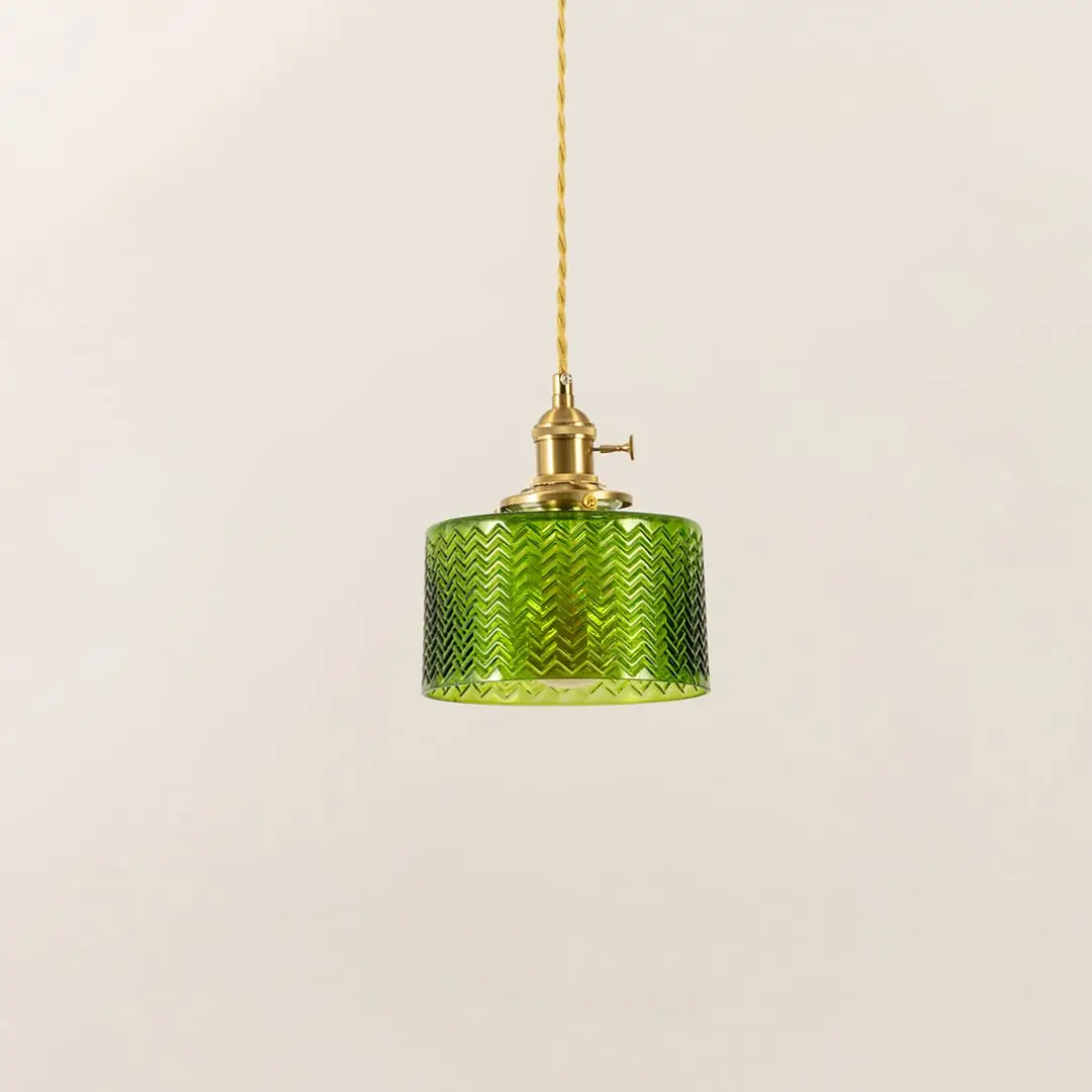Green textured glass and brass metal pendant light designed for contemporary dining room interiors.
